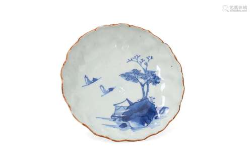 A blue and white porcelain deep saucer with scalloped rim, d...