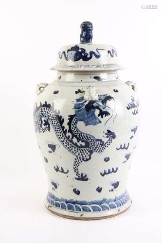 A blue and white porcelain lidded jar, decorated with two dr...