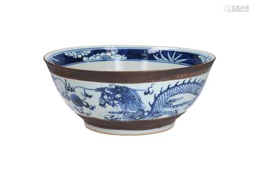 A blue and white porcelain bowl, decorated with dragons chas...