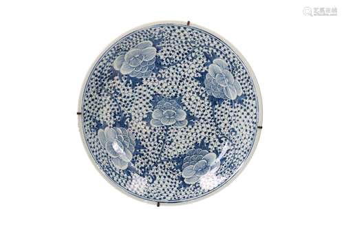 A blue and white porcelain charger, decorated with flowers. ...