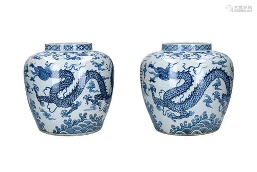 A pair of blue and white porcelain jars, decorated with drag...