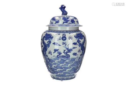 A blue and white porcelain lidded jar, decorated with dragon...