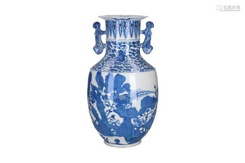 A blue and white porcelain vase with ears, decorated with bi...