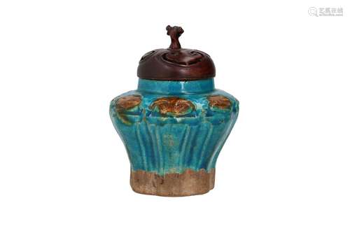 A blue and brown glazed Fahua ware jar with wooden lid. Unma...