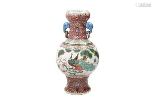 A polychrome porcelain vase with two handles in the shape of...