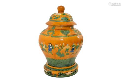 A sancai glazed earthenware lidded jar, decorated with a ban...