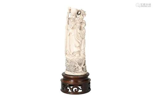 A carved ivory sculpture on wooden base, depicting figures w...