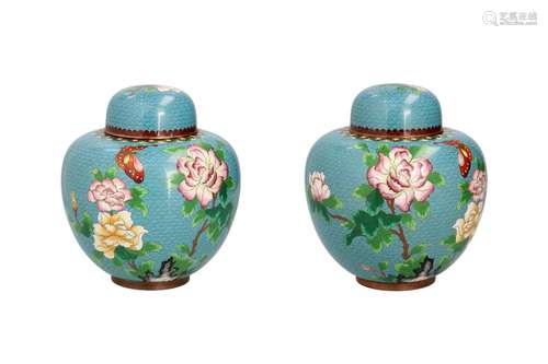 A pair of cloisonné lidded jars, decorated with flowers and ...