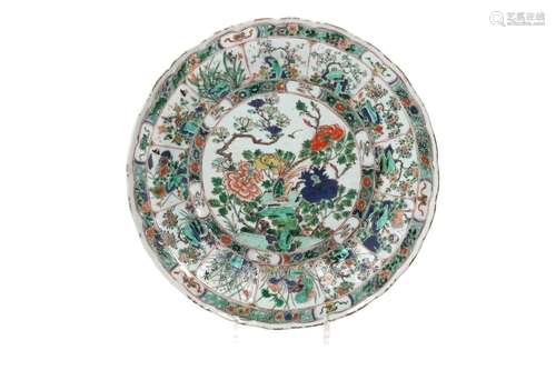 A famille verte porcelain charger with scalloped rim, decora...