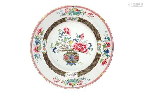 A famille rose porcelain charger, decorated with flowers and...