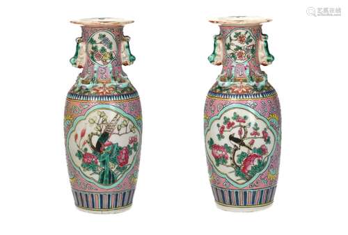 A pair of famille rose porcelain vases with grips in the sha...