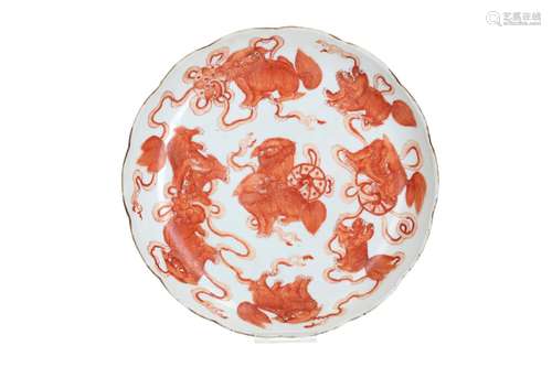 An iron red and white porcelain dish with scalloped rim, dec...