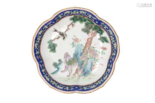 A famille rose porcelain serving dish with scalloped rim on ...