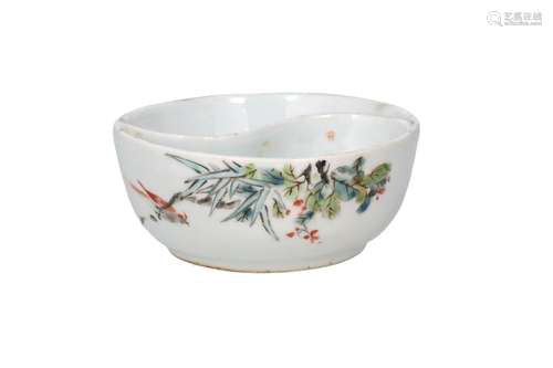 A polychrome porcelain bowl with two compartments in the sha...