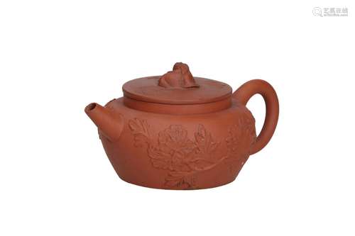 A Yixing teapot with relief decor of flowers and antiquities...