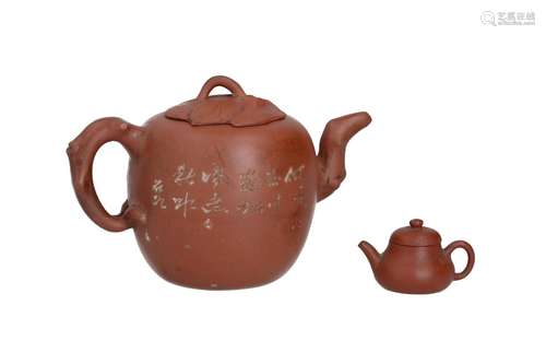 A Yixing teapot with a spout and handle in the shape of bran...