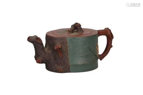 A Yixing teapot with polychrome relief decor of flowers. The...