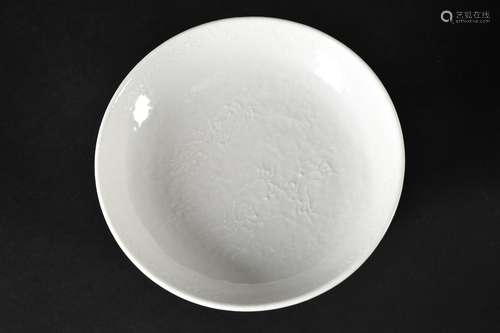 A blanc de Chine porcelain deep saucer with relief decor of ...