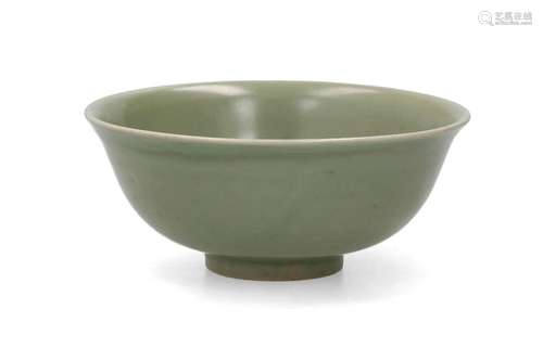 A celadon glazed porcelain bowl with in the center a decor o...