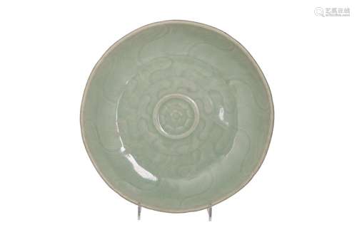 A celadon glazed porcelain deep dish with relief decor of wa...