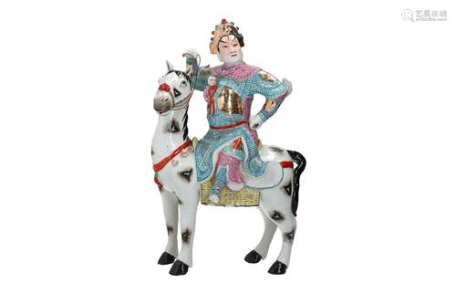 A polychrome porcelain sculpture depicting a figure on a hor...