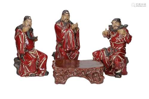 A set of four red glazed Shiwan ware sculptures, depicting t...