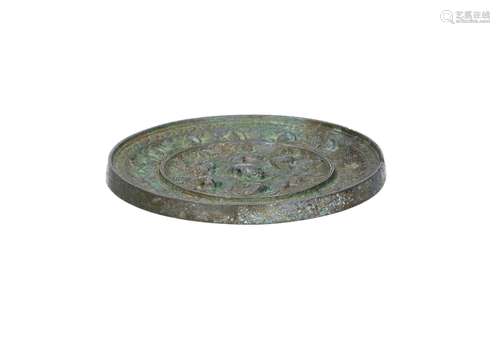 A bronze mirror with relief decor of lions and grapes. China...