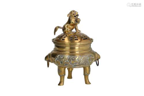 A bronze tripod censer with two handles. The cover with grip...