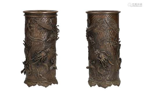 A near-pair of bronze beaker vases with relief decor of drag...