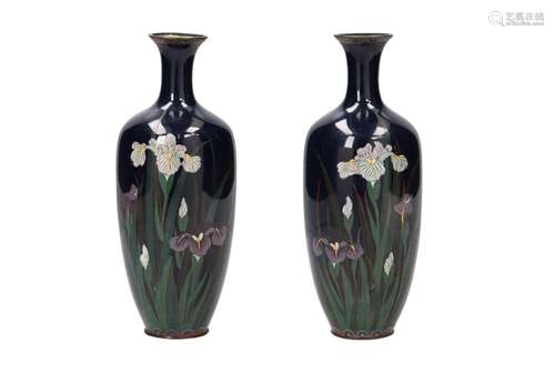 A pair of polychrome cloisonné vases, decorated with flowers...