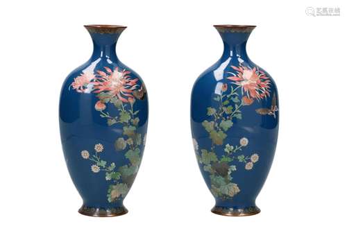 A pair of polychrome cloisonné vases, decorated with flowers...