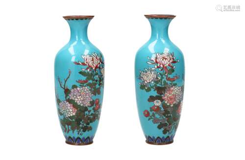 A pair of polychrome cloisonné vases, decorated with flowers...