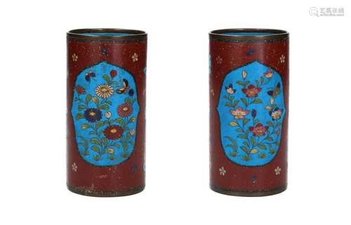 A pair of polychrome cloisonné vases, decorated with reserve...