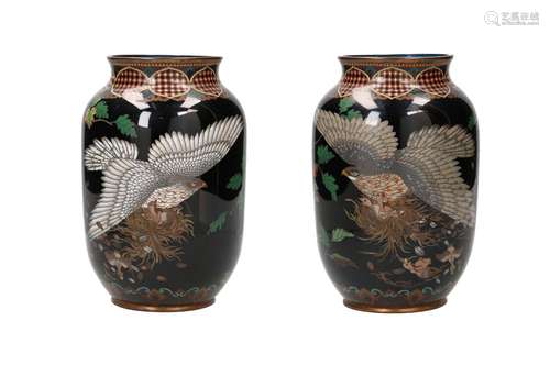 A pair of polychrome cloissoné vases, decorated with birds o...