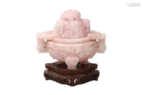 A carved rose quartz censer on wooden base, decorated with b...