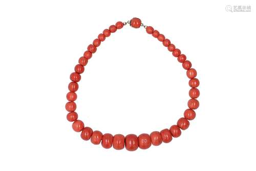 A red coral necklace with 14-kt golden clasp set with red co...