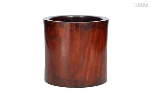 A cylindrical huanghuali brushpot with caramel hue. The base...