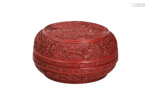 A round cinnabar lidded box, with carved decor depicting a g...