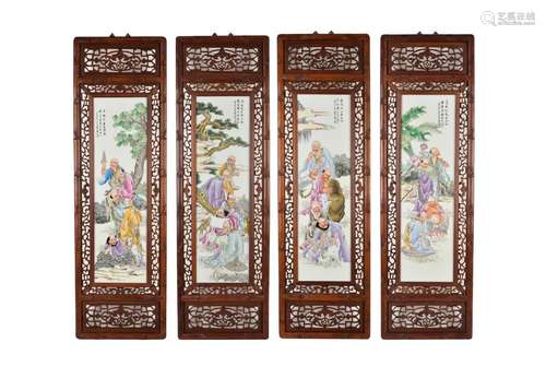 A set of four polychrome porcelain plaques in wooden frames,...