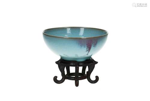 A Jun ware bowl with splash decor, on wooden base. After Son...