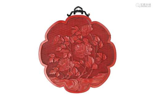 A lacquer cinnabar panel in the shape of a flower, with reli...