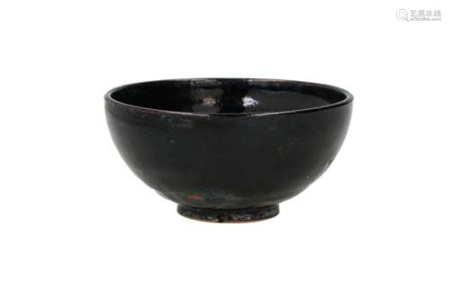 A black glazed stoneware tea bowl. Unmarked. China, Cizhou, ...