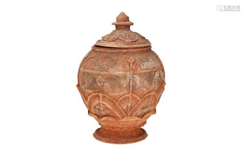 A terracotta lidded jar with relief decor. Unmarked. China, ...