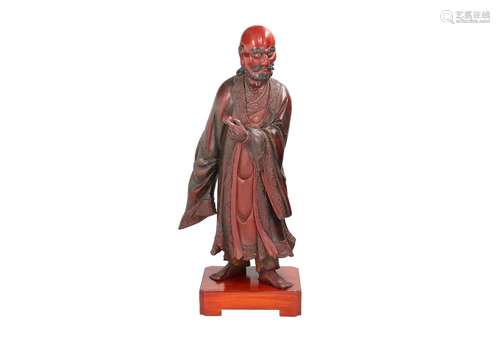 A lacquered wooden sculpture depicting Damo, a Buddhist figu...