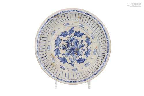 A stoneware deep bowl with underglaze blue decor of a peony....