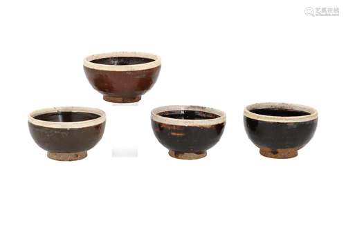 A set of four brown glazed Cizhou stoneware bowls with white...