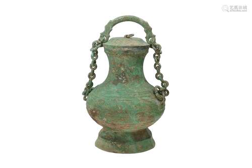 A bronze lidded wine vessel (Zun) with chain connecting the ...