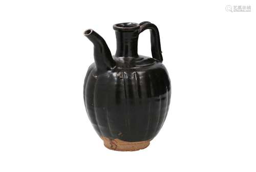 A black glazed stoneware ewer with lobed body. Unmarked. Chi...