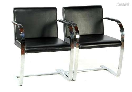2 chrome-plated metal armchairs