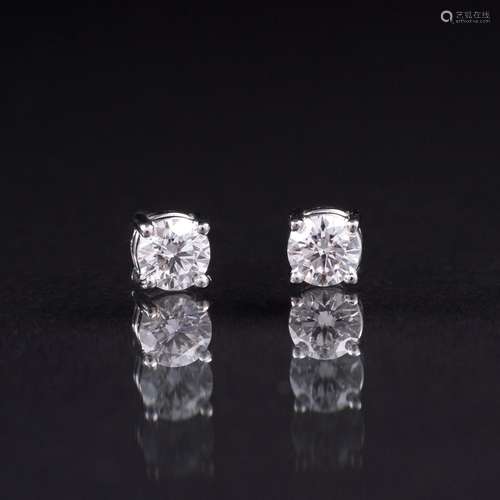 A Pair of Rare-White Solitaire Earstuds.